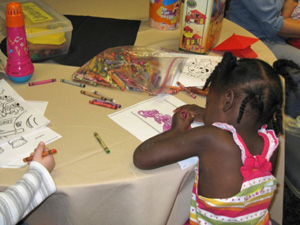 child coloring with crayons